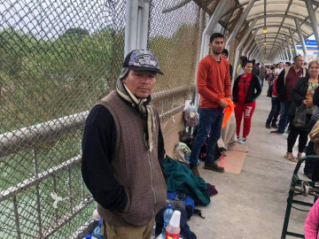 Con frio, esperan migrantes asilo político en el Puente Internacional 