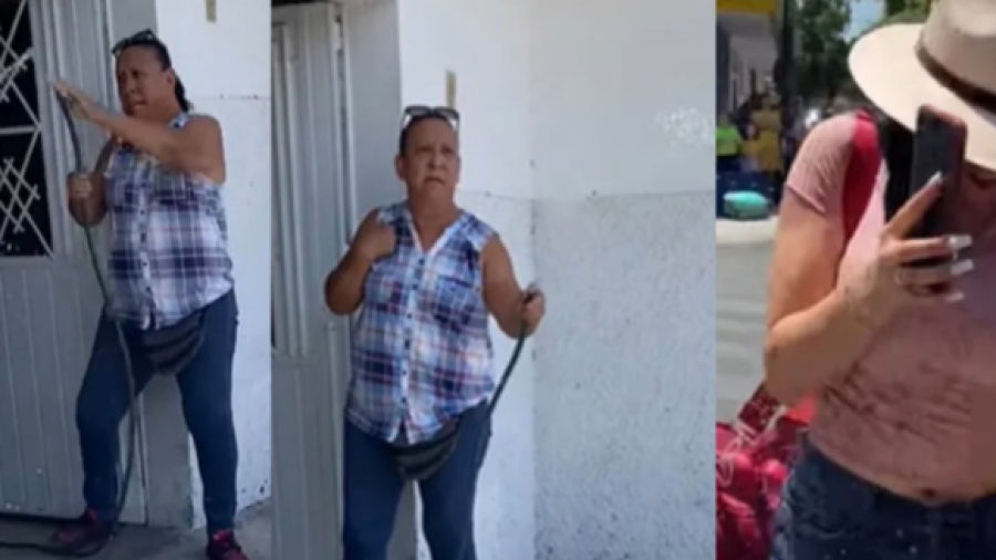 Mujer baña a manguerazos a turistas por pararse en su banqueta