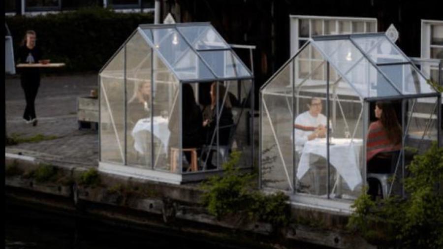 Restaurante implementa jaulas de cristal para mesas